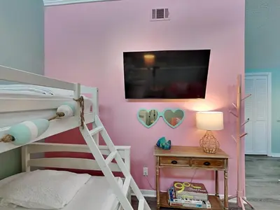 a bedroom with a bunk bed and a tv on a wall at Southwind I Condo #K8 in Panama City Beach