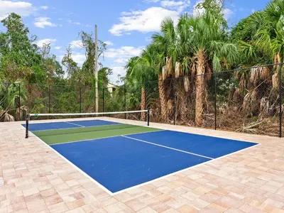 a tennis court with a blue and green at Southwind I Condo #K8 in Panama City Beach