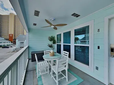 a patio with a table and chairs on a balcony at Southwind I Condo #K8 in Panama City Beach