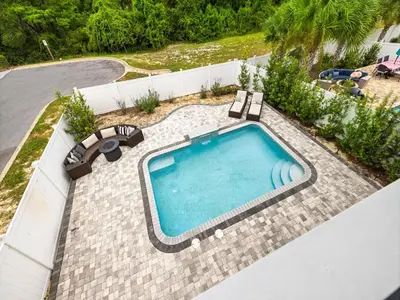 an overhead view of a swimming pool with chaise lounge chairs and a swimming pool at Sugar Sands in Panama City Beach