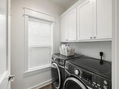 a kitchen with a black washing machine in a room at Sugar Sands in Panama City Beach