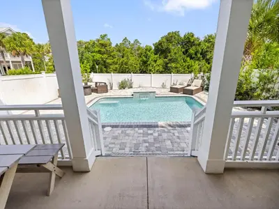 a view of a swimming pool from the balcony of a house at Sugar Sands in Panama City Beach