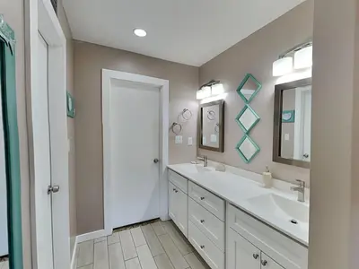 a bathroom with two sinks and a mirror at Edgewater Villa #1902 in Panama City Beach