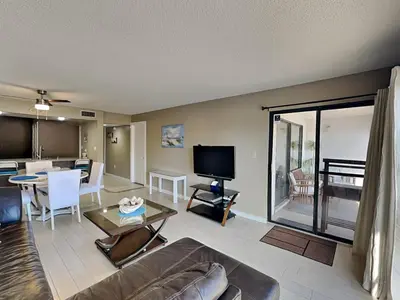 a living room with a couch and a dining room at Edgewater Villa #1902 in Panama City Beach