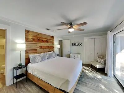 a bedroom with a bed and a ceiling fan at Cassine Gardens #101 in Seagrove Beach