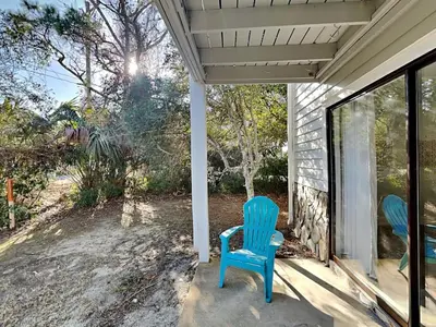 two blue chairs sitting on the porch of a house at Cassine Gardens #101 in Seagrove Beach