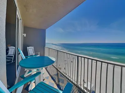 a balcony with a table and chairs and the ocean at Tidewater Beach Resort #503 in Panama City Beach