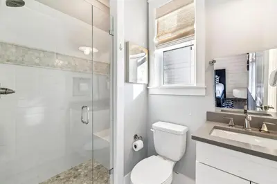 a bathroom with a toilet and a sink and a shower at Casablanca By The Sea by 30A Escapes in Rosemary Beach