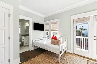 a white bedroom with a bed and a window at Casablanca By The Sea by 30A Escapes in Rosemary Beach