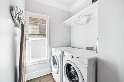 a white laundry room with a washer and dryer at Casablanca By The Sea by 30A Escapes in Rosemary Beach