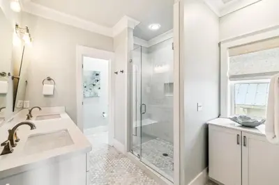 a white bathroom with a shower and a sink at Casablanca By The Sea by 30A Escapes in Rosemary Beach
