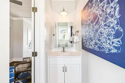 a bathroom with a sink and a painting on the wall at Casablanca By The Sea by 30A Escapes in Rosemary Beach