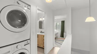 a white laundry room with a washer and dryer at Sandbar Serenade by AvantStay Beachside Home Pool Tennis Court Beach Access Near Pier Park in Panama City Beach