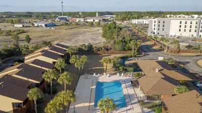 an aerial view of a resort with a swimming pool at Sandbar Serenade by AvantStay Beachside Home Pool Tennis Court Beach Access Near Pier Park in Panama City Beach