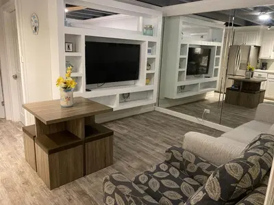 a living room with a television and a couch at Tiny home living!! First floor condo! in Panama City Beach