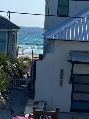 a house with a view of the ocean from the beach at Tiny home living!! First floor condo! in Panama City Beach