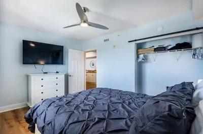 a bedroom with a bed and a ceiling fan at Emerald Beach 2030 by Emerald Coast Retreats in Panama City Beach