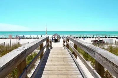 a wooden boardwalk leading to a beach with the ocean at Emerald Beach 2030 by Emerald Coast Retreats in Panama City Beach
