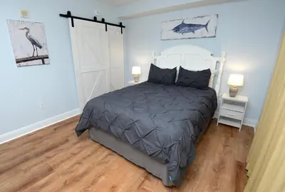 a bedroom with a large bed and two lamps at Emerald Beach 2030 by Emerald Coast Retreats in Panama City Beach