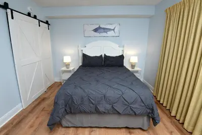 a bedroom with a large bed and two lamps at Emerald Beach 2030 by Emerald Coast Retreats in Panama City Beach