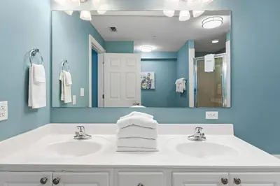 a bathroom with two sinks and a large mirror at Sunrise Beach 17th Floor 3BR Condo | Oversized Balcony, Heated Pool, Near Pier Park in Panama City Beach