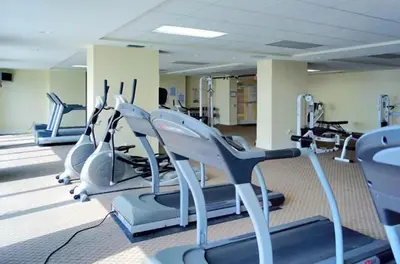 a gym with several treadmills and cardio machines at Sunrise Beach 17th Floor 3BR Condo | Oversized Balcony, Heated Pool, Near Pier Park in Panama City Beach