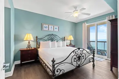 a bedroom with a bed with a view of the ocean at Sunrise Beach 17th Floor 3BR Condo | Oversized Balcony, Heated Pool, Near Pier Park in Panama City Beach