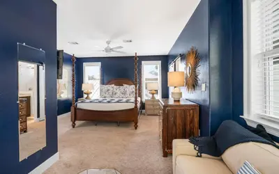a blue room with a bed and a couch at 30A Stars and Stripes in Seagrove Beach