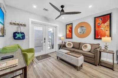 a living room with a couch and a table at Pelican's Roost in Santa Rosa Beach