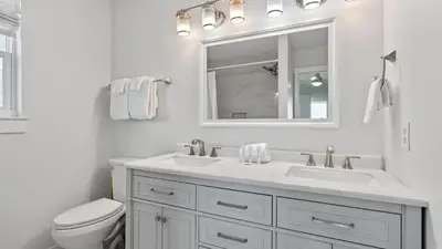 a white bathroom with a sink and a toilet at Sandy Pelican by AvantStay Exclusive Beach Access Private Pool Firepit Balcony Sunset Views in Seacrest