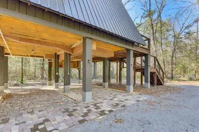 a house with a metal roof and a staircase at Near Hiking! Angler Oasis with Hot Tub in Florida