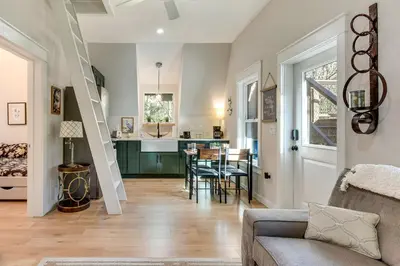 a living room with a staircase and a dining room at Near Hiking! Angler Oasis with Hot Tub in Florida