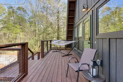 a wooden deck with a table and chairs on it at Near Hiking! Angler Oasis with Hot Tub in Florida