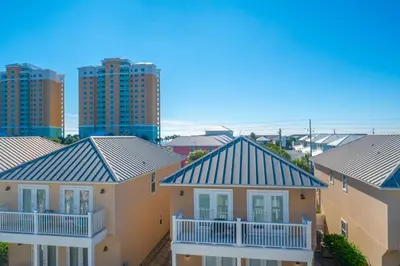 a row of houses with buildings in the background at Beach Getaway for 15 A Few Steps from the Sand in Panama City Beach