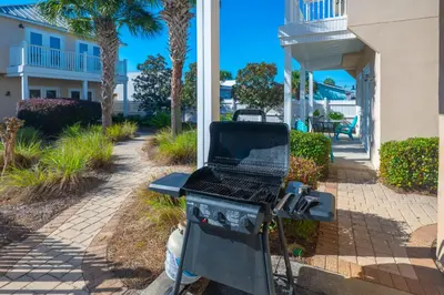 a bbq grill in front of a house at Beach Getaway for 15 A Few Steps from the Sand in Panama City Beach