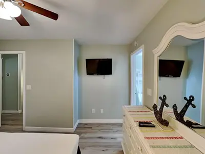 a bedroom with a bed and a large mirror at Gulf Highlands #195 in Panama City Beach
