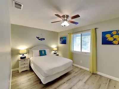 a bedroom with a bed and a ceiling fan at Gulf Highlands #195 in Panama City Beach