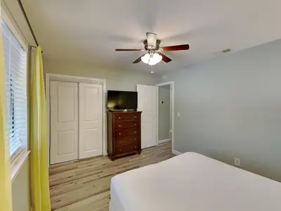 a bedroom with a bed and a ceiling fan at Gulf Highlands #195 in Panama City Beach