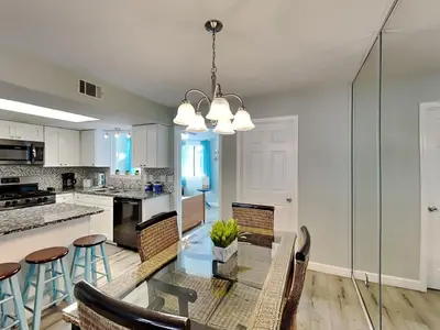 a kitchen and dining room with a table and chairs at Gulf Highlands #195 in Panama City Beach