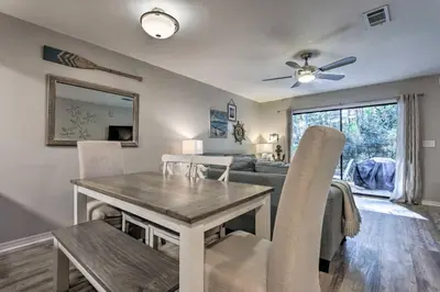 a dining room and living room with a table and chairs at 30As Favorite Beach Condo- 6 min walk to the beach in Santa Rosa Beach