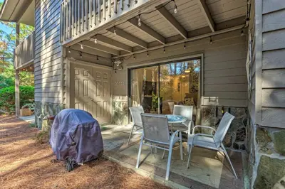 a patio with chairs and a table on a house at 30As Favorite Beach Condo- 6 min walk to the beach in Santa Rosa Beach