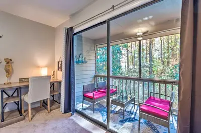 a room with a balcony with a table and chairs at 30As Favorite Beach Condo- 6 min walk to the beach in Santa Rosa Beach