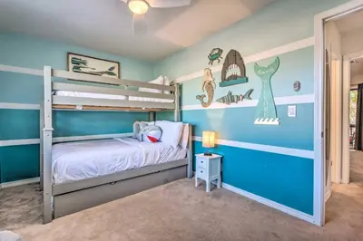 a bedroom with blue walls and a bunk bed at 30As Favorite Beach Condo- 6 min walk to the beach in Santa Rosa Beach