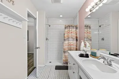 a white bathroom with a sink and a shower at Emerald Escape 1 - 3 Blocks to Beach in Panama City Beach