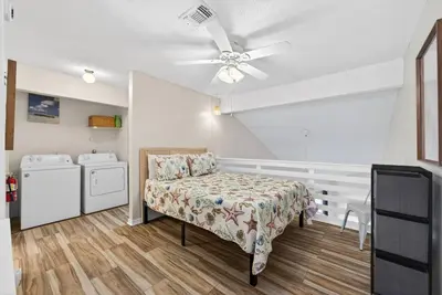 a bedroom with a bed and a ceiling fan at Emerald Escape 1 - 3 Blocks to Beach in Panama City Beach