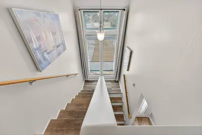 a staircase in a house with a window at Emerald Escape 1 - 3 Blocks to Beach in Panama City Beach