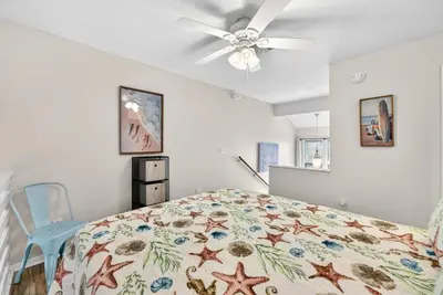 a bedroom with a bed and a ceiling fan at Emerald Escape 1 - 3 Blocks to Beach in Panama City Beach