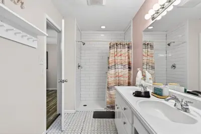 a white bathroom with a sink and a shower at Emerald Escape - 3 Blocks to Beach in Panama City Beach
