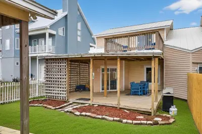 a house with a deck in a yard at Emerald Escape 2 - 3 Blocks to Beach in Panama City Beach