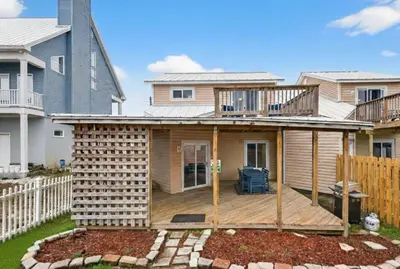 a house with a deck in a yard at Emerald Escape 2 - 3 Blocks to Beach in Panama City Beach
